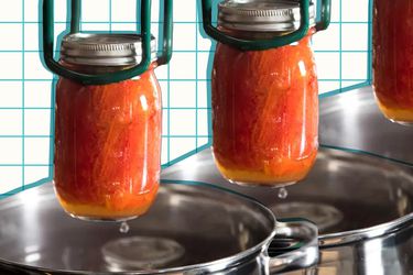 Canned tomatoes being lifted from a pot