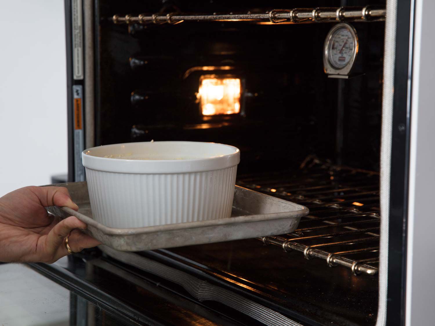 Placing the soufflé in the oven to cook.