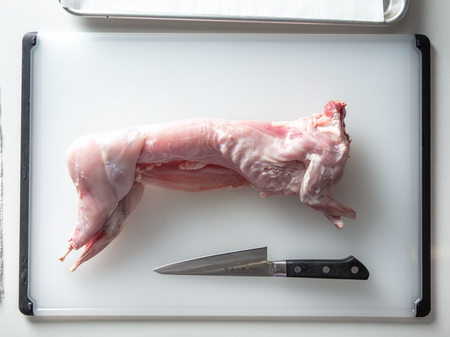 Whole rabbit on a cutting board.
