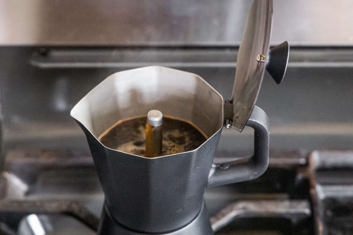Coffee brewing in a black moka pot