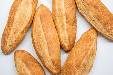Overhead view of 6 banh mi bread loafs
