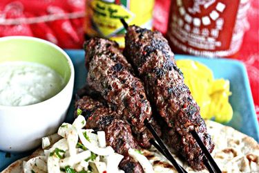 Grilled beef kebabs, served on flatbread over onion salad with a ramekin of yogurt-mint sauce.