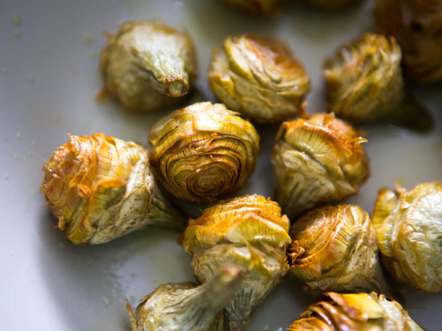 Tender fried artichoke hearts after first round of frying. 