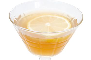 A closeup of a The King's Waes Hail cocktail, served in a strange coupe glass.