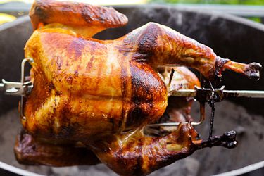 A turkey being cooked on a rotisserie. 