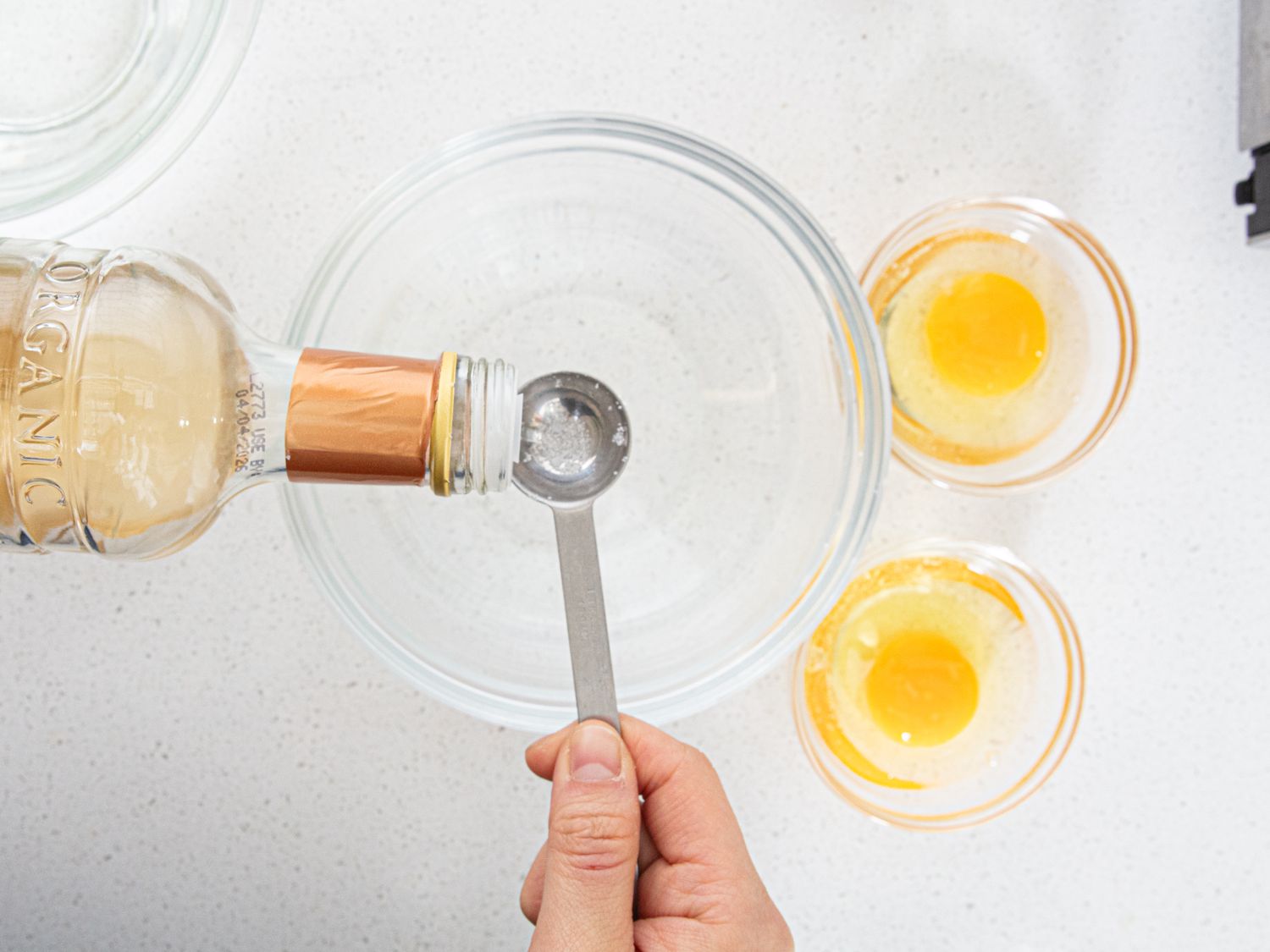 Overhead view of adding vingear to water 