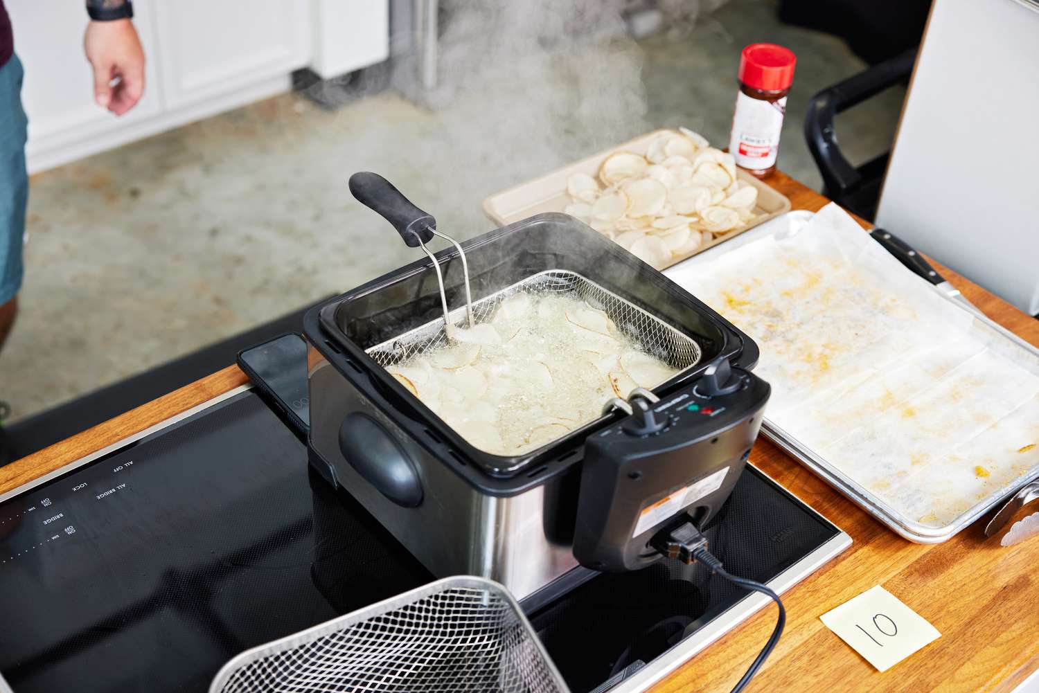 A deep fryer cooking potatoes 