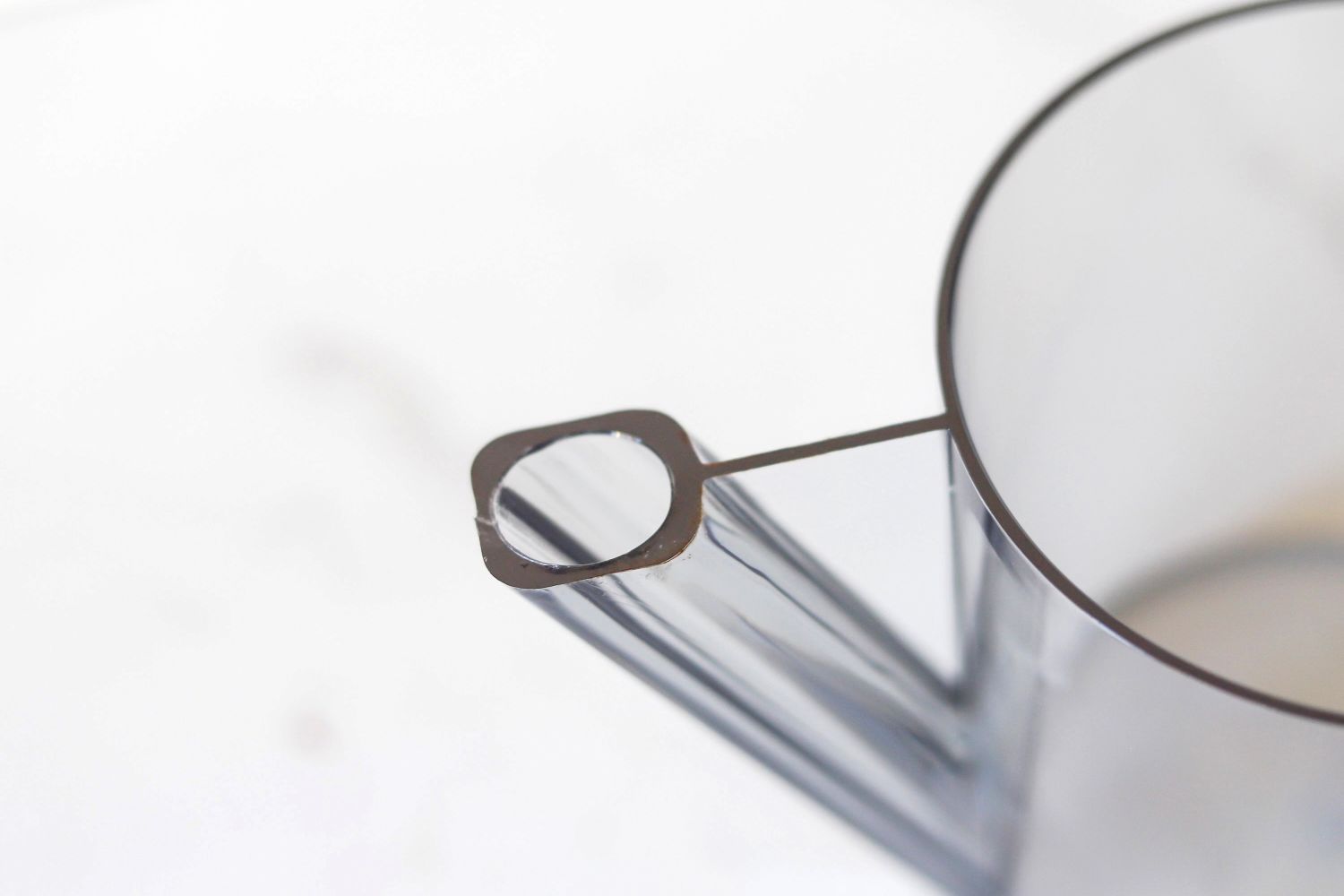 Closeup of a transparent plastic cup with a handle