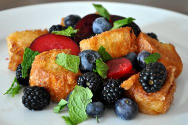 Closeup of plate full of summer fruit panzanella.