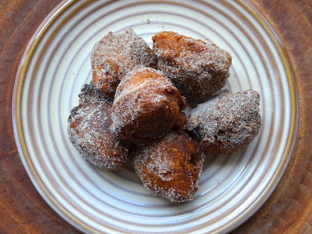 Overhead view of a plate piled high with apple brandy doughnut holes.