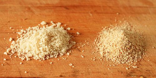 Two piles of ground up grain next to each other on a cutting board.