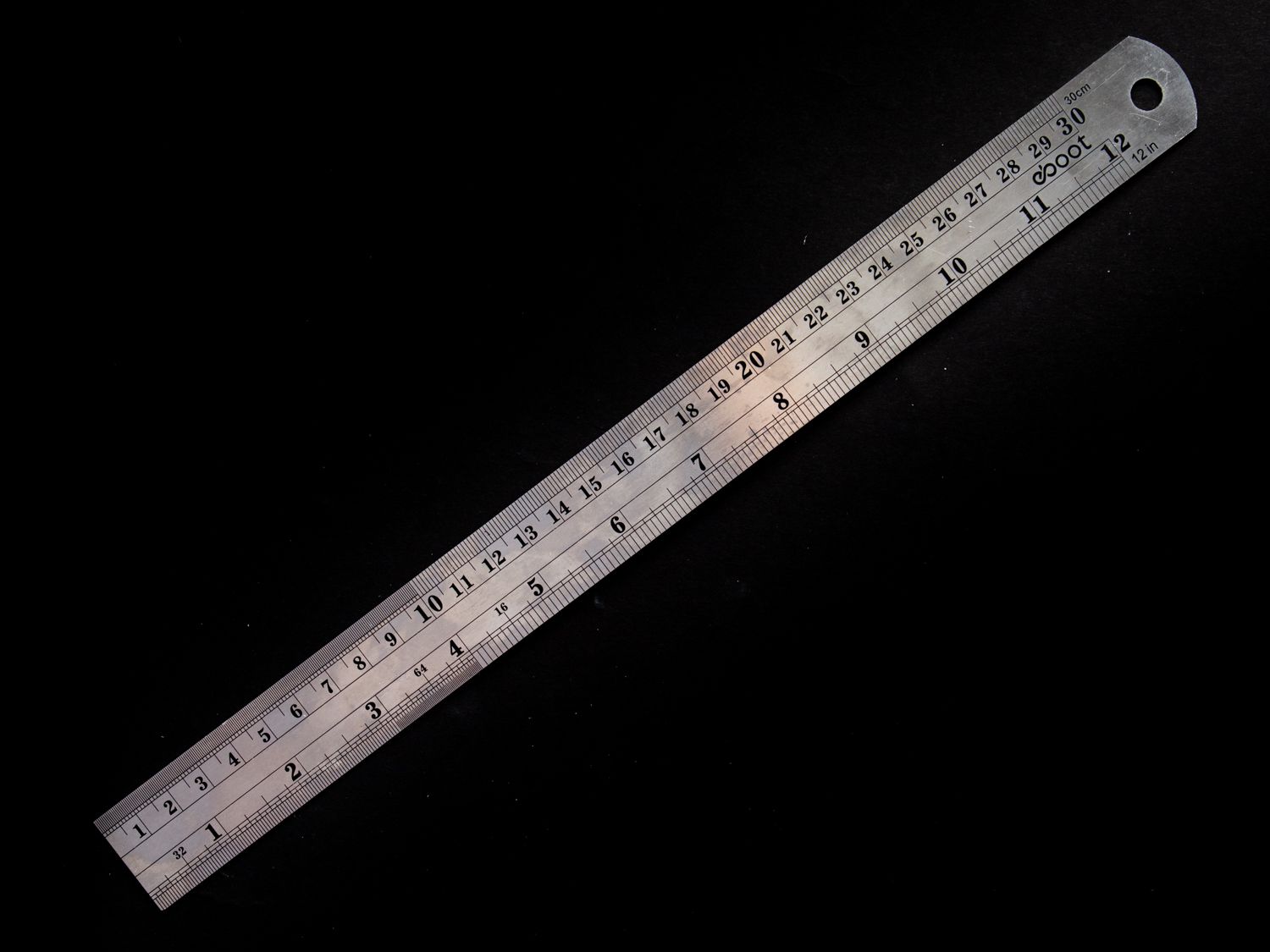 A metal ruler on a black background