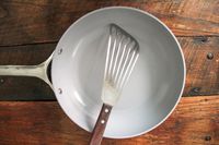 A spatula on the Caraway Nonstick Ceramic Frying Pan
