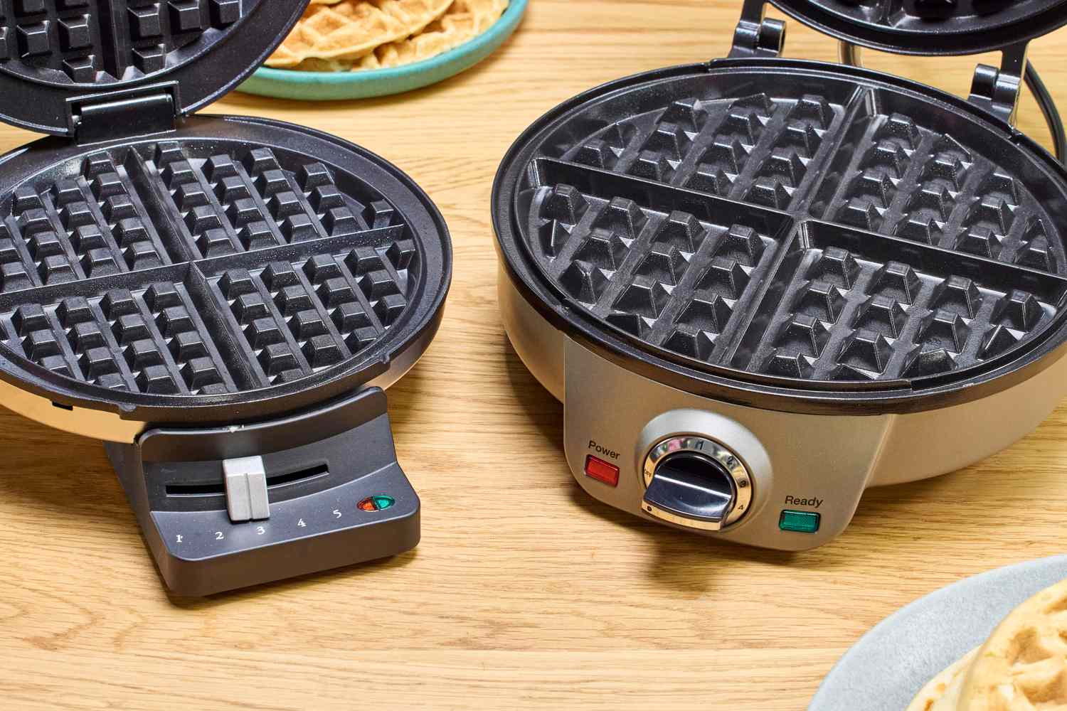 Two open waffle makers, with a focus on the plate design of each one.