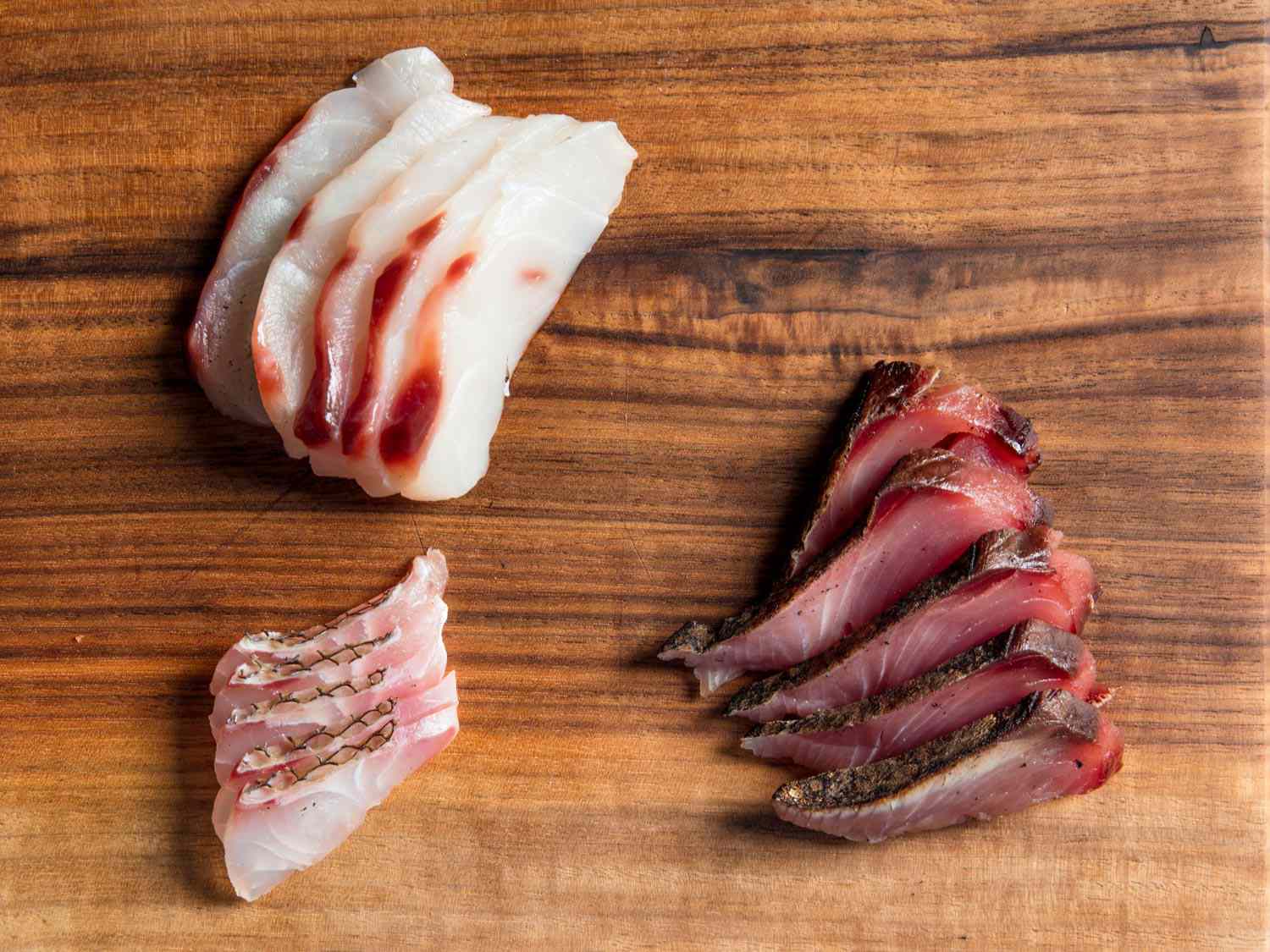 Sashimi slices of sea bass, torched Spanish mackerel, and porgy yubiki. 