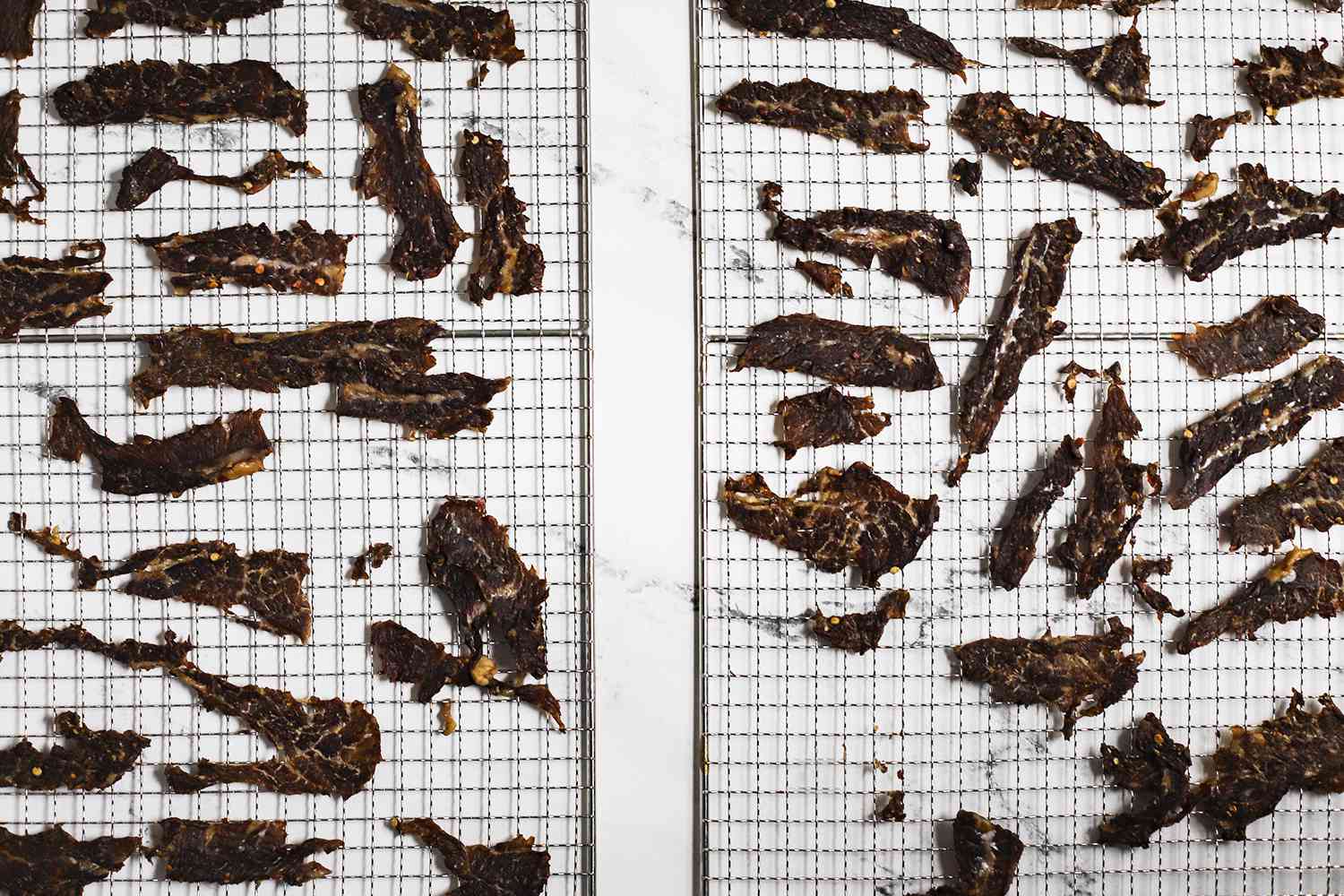 beef jerky on cooking racks after running through a dehydrator