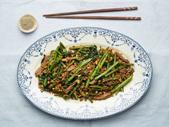 Overhead view of sauteed morning glory with beef on a plate
