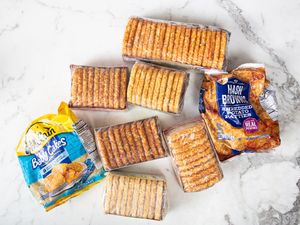 A variety of frozen hash brown products arranged on a marble surface