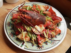 A plate of Cantonese-style lobster with ginger and scallions.