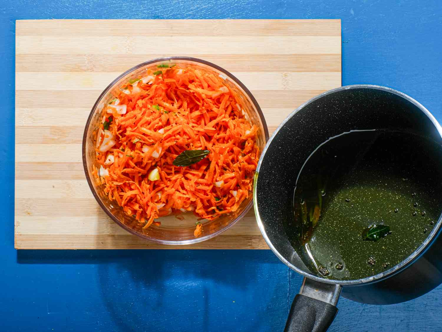The fried spices and oil are added to the salad.