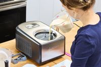 A person pouring liquid into the Cuisinart Compressor Ice Cream and Gelato Maker