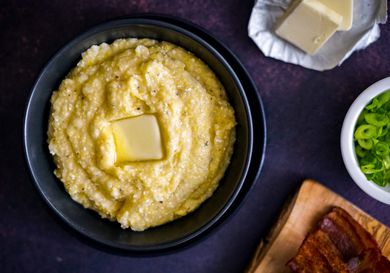 A bowl of homemade grits topped with a square of butter