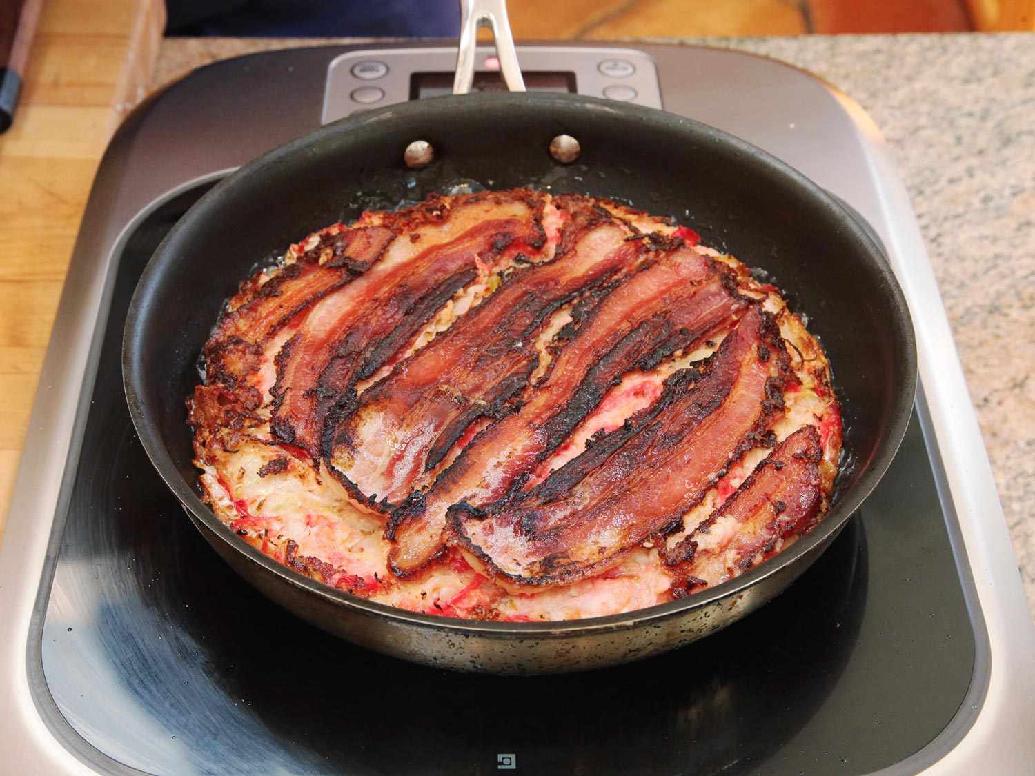 Golden brown sliced pork belly on okonomyaki, a Japanese pancake