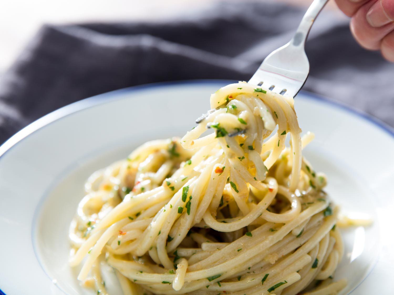 Picking up a forkful of spaghetti with colatura, an Italian fish sauce.