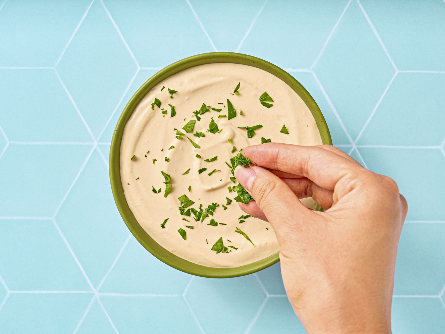 Overhead view of garnishing dip