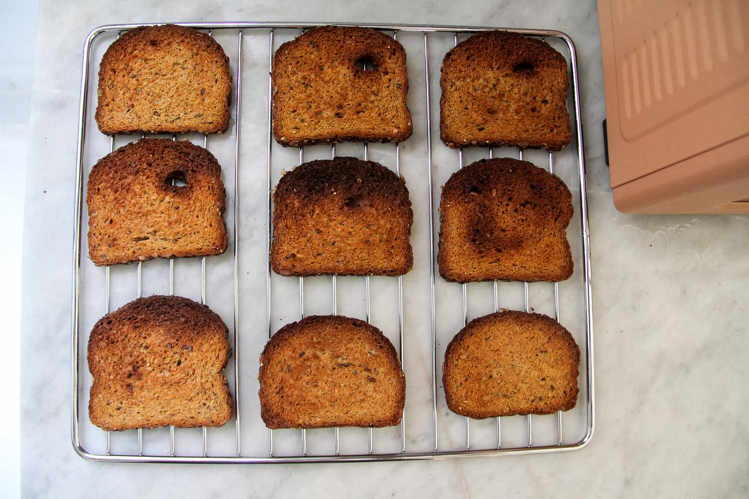 Slices of toasted bread arranged on a wire rack