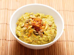 Closeup of Chipotle-Orange Guacamole With Toasted Pumpkin Seeds.