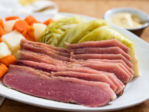A plate of corned beef, cabbage, potatoes, and carrots. 