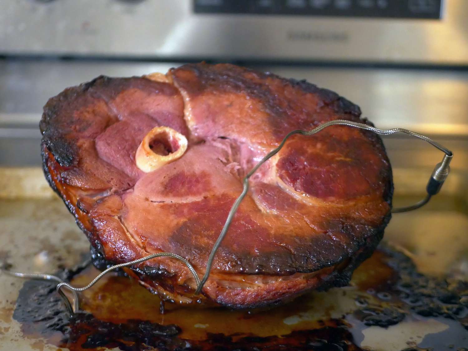 snake river farm ham cooked on a sheet tray with a probe in it