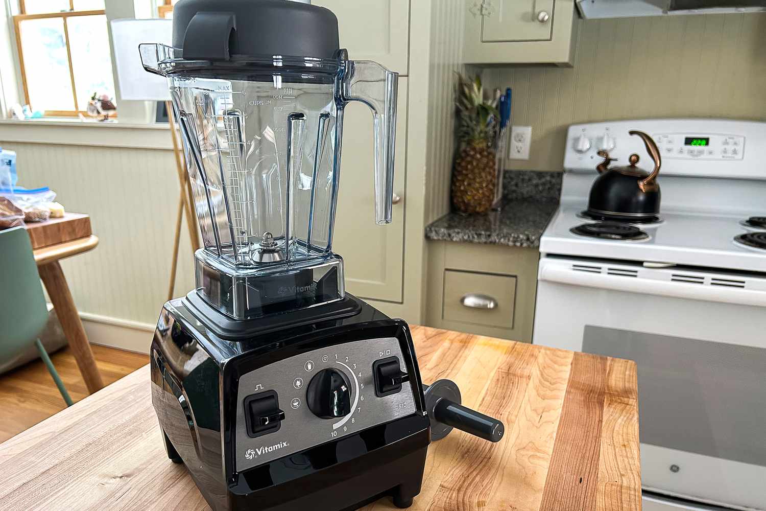 The Vitamix Propel 510 blender on a wooden butcher block in a kitchen.
