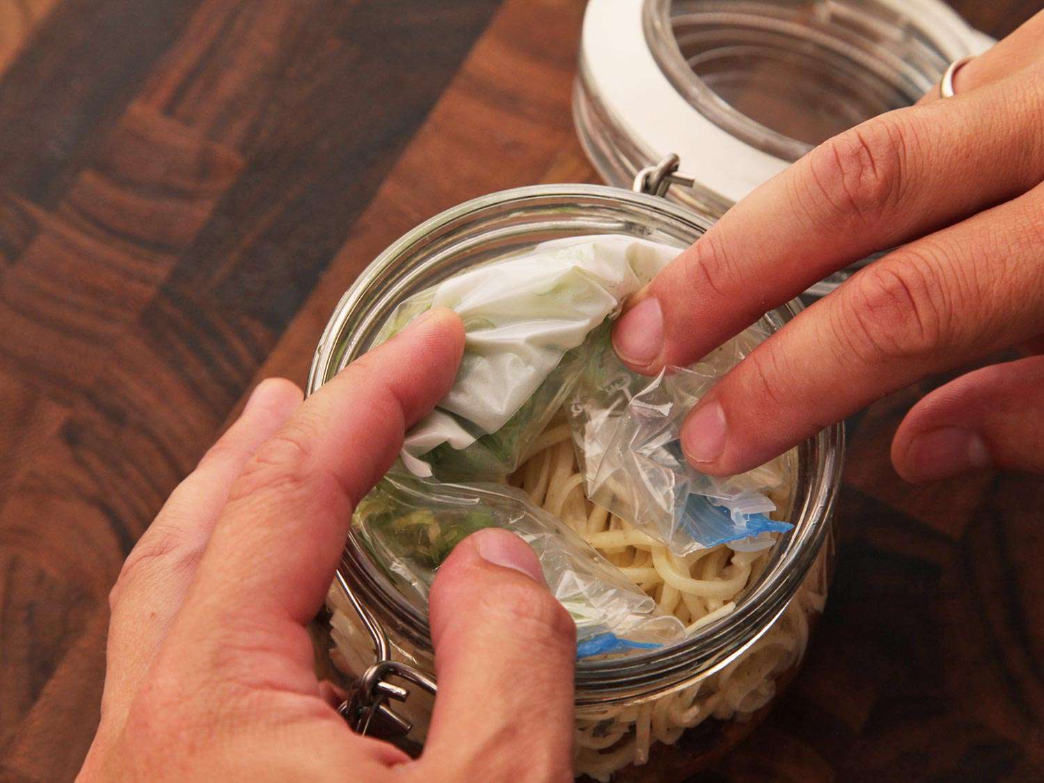 The rolled-up bag is added to the clip top jar.