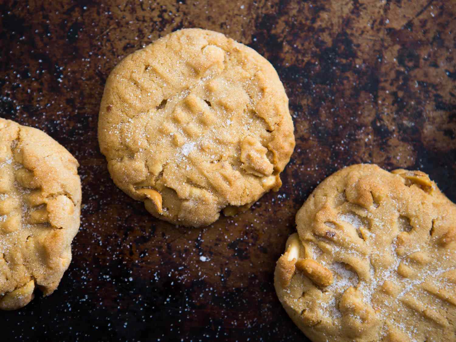 Overhead close-up of peanut butter cookies, sprinkled with sugar.