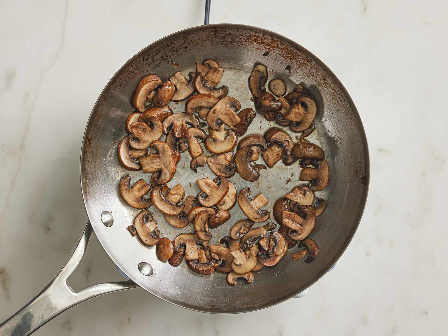 Mushrooms sauteing in skillet 