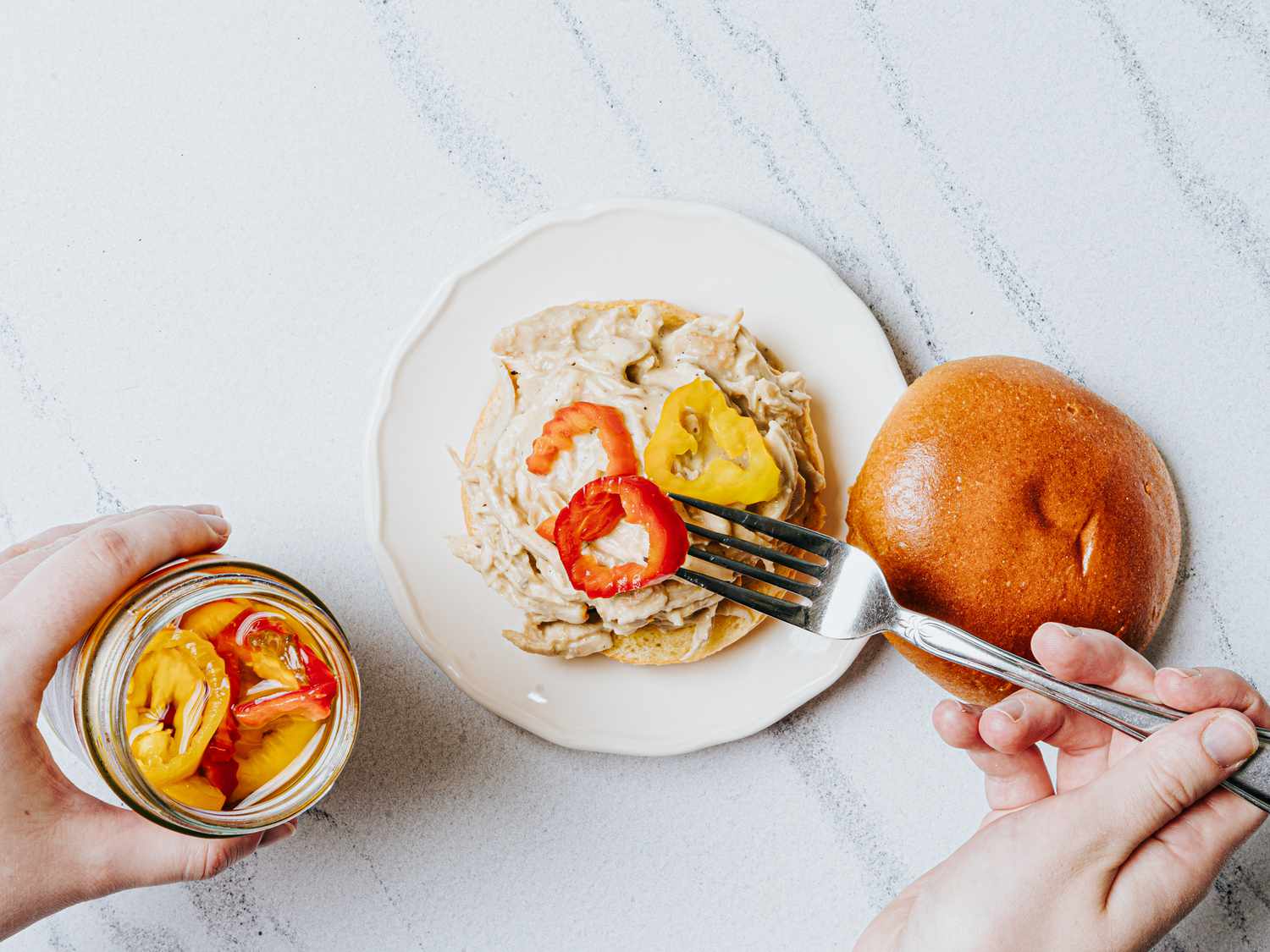 adding banana peppers to sandwich
