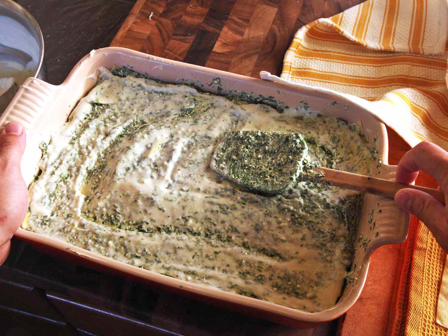 Smoothing out white sauce with the back of a spatula