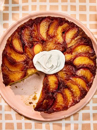 Overhead view of finished peach upside down cake with a slice removed