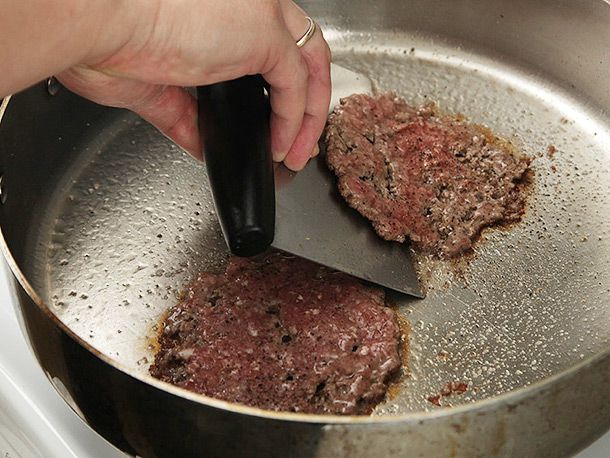 Scraping smashed patty off stainless steel skillet