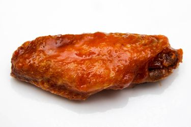 Closeup of a glistening Buffalo wing.