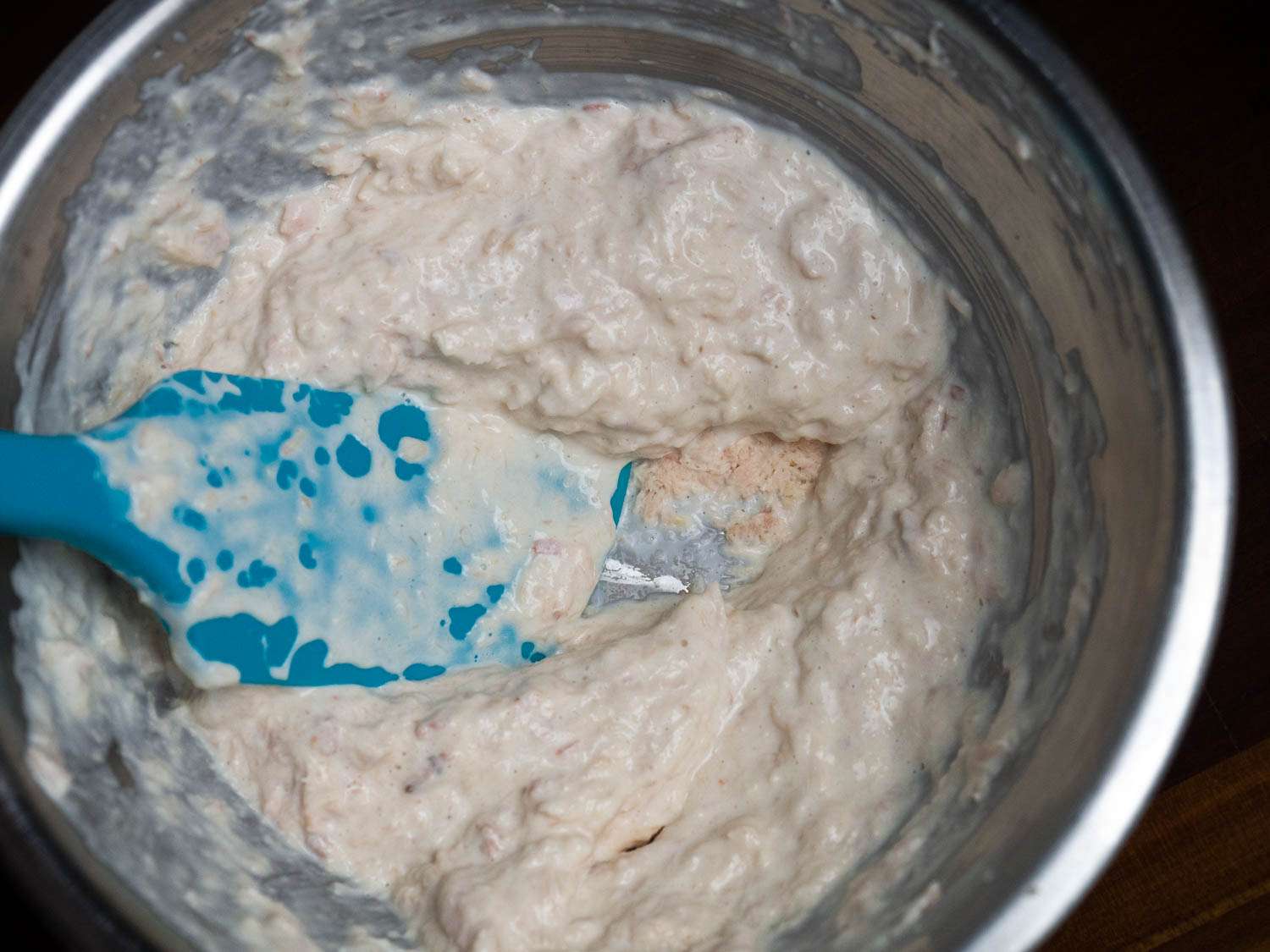 Using a spatula to smash every last flake of tuna to smithereens in a mixing bowl