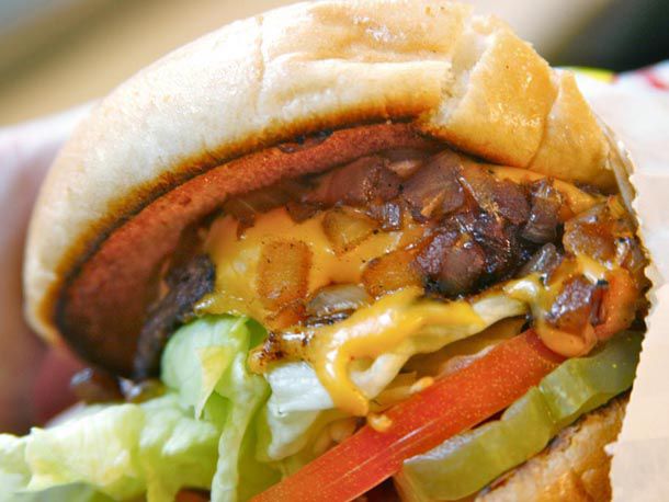 An In-N-Out burger with grilled onions on top of the patty