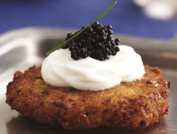 Closeup of a Latke topped with Caviar and Sour Cream