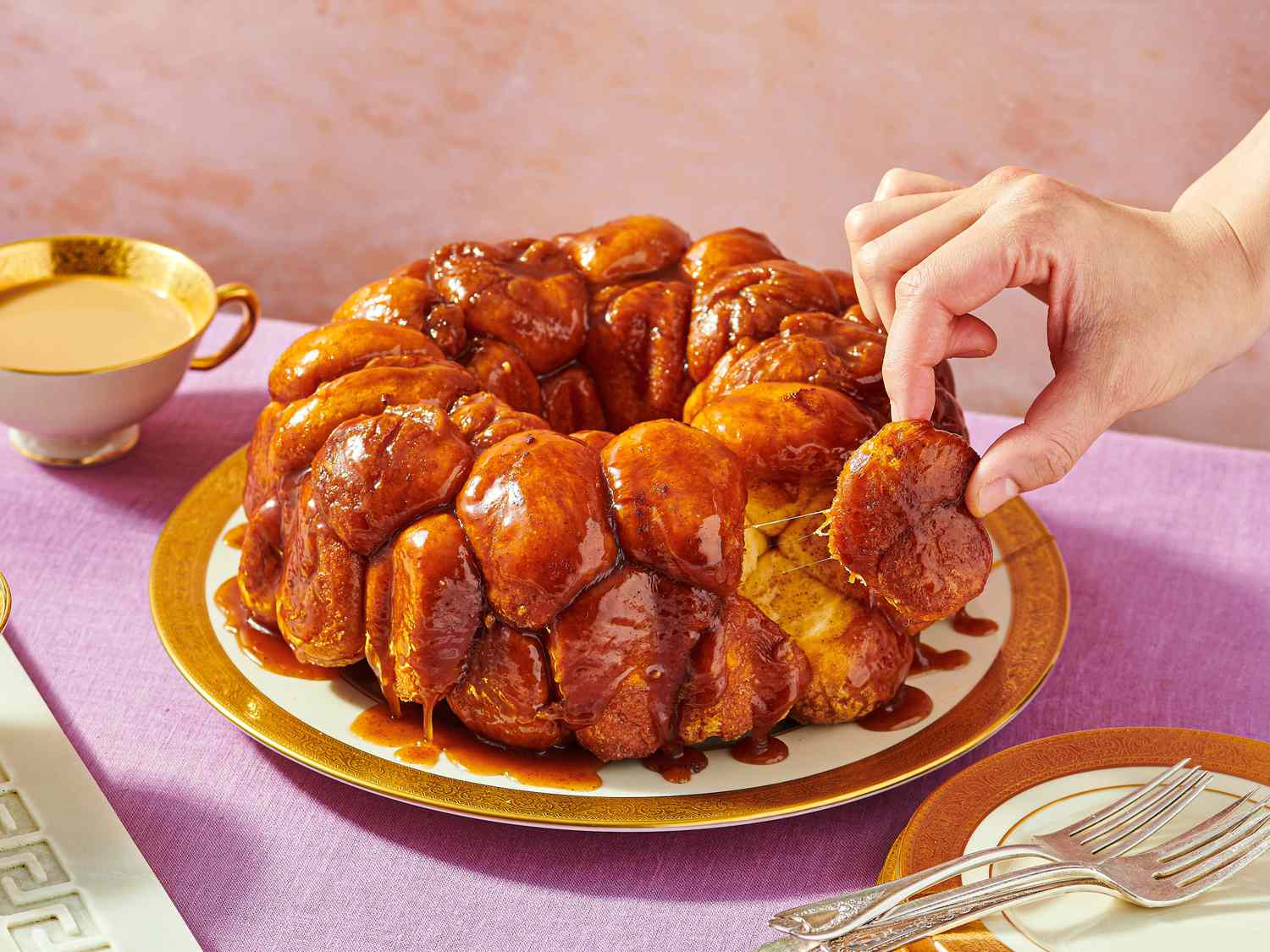Monkey bread on a plate, person lifting a piece