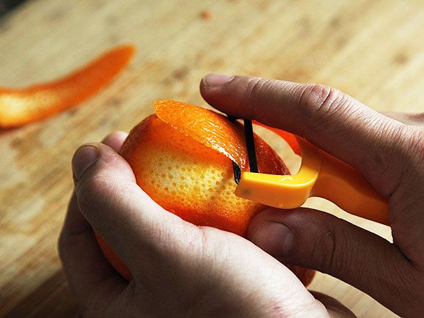 Peeling an orange for orange chicken sauce.