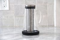 The Ovalware cold brew maker on a marble kitchen countertop.