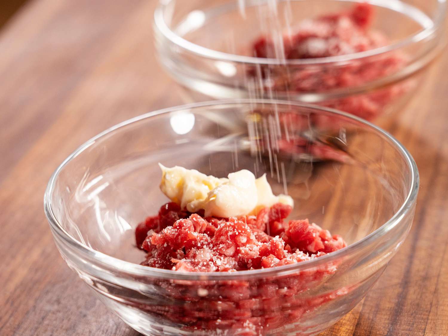 small bowls of diced raw beef with mayonaise and salt