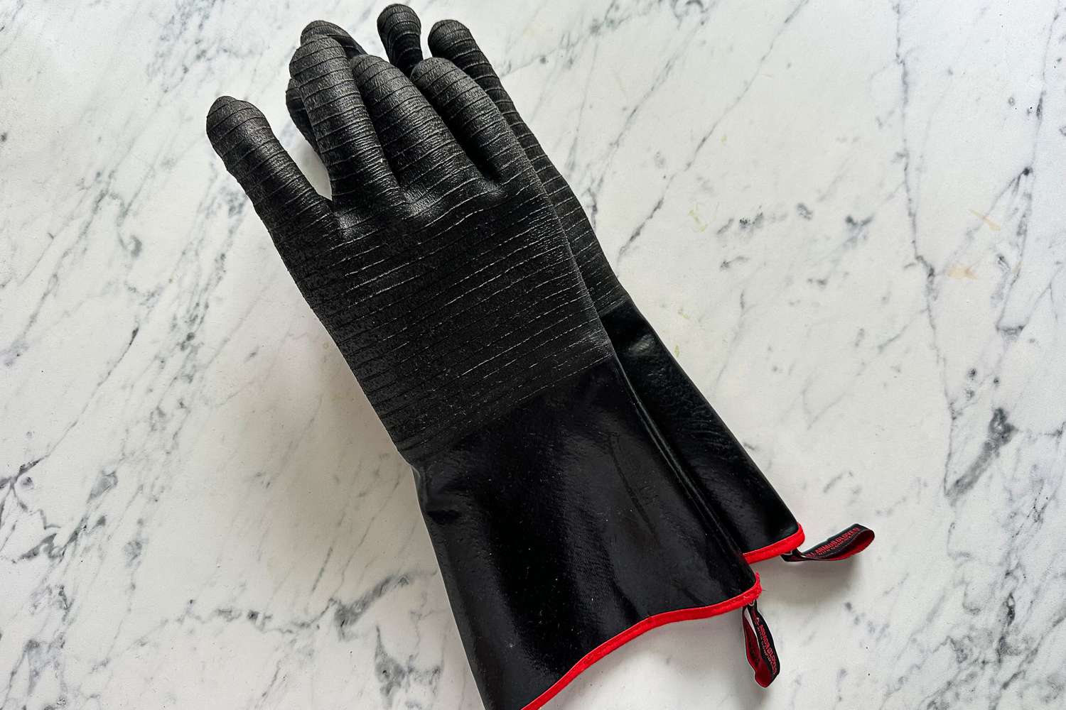 A pair of Grill Armor Gloves BBQ Waterproof Gloves on a kitchen countertop